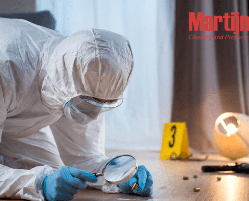 blood cleanup technician checking the ground with magnifying glass